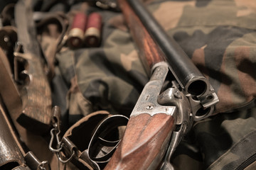 antique double-barreled shotgun, knife and ammunition belt