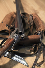 antique double-barreled shotgun, knife and ammunition belt