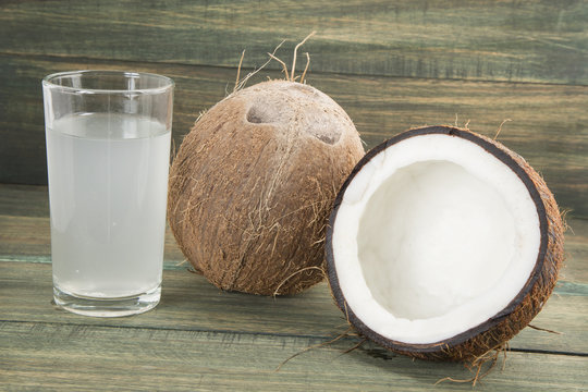 Coconut water on the wooden background (Cocos nucifera)