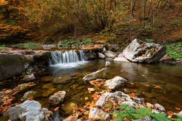Fototapeta na wymiar The waterfall near the rock bridge Shapran dupka, the village of Belitsa, Bulgaria