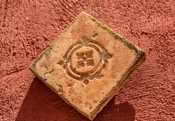 Antique carved stone on a red surface
