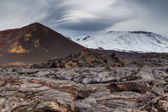 Two years old lava filed and volcano in background, Kamchatka, Russia.