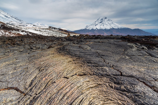 Two years old lava filed and volcano in background, Kamchatka, Russia.