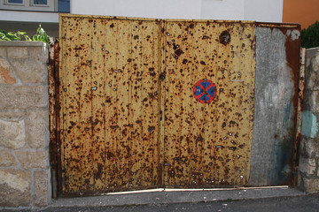 Yellow gate riddled with bullets from the gun during the Balkan War