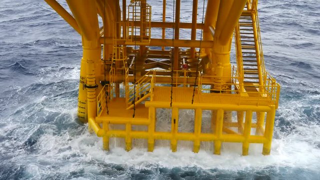 High Waves Hit Oil and Gas Producing Slots and Platform Legs at Offshore Platform - Oil and Gas Industry

