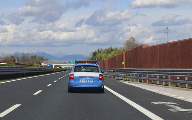 Fototapeta na wymiar Italian police car patrolling on the highway