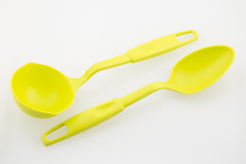 Large plastic spoons on white background