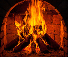 A fire burns in a fireplace