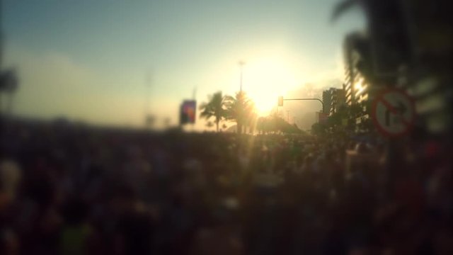 Sunset over carnival crowd celebrating at a banda street party in Ipanema Beach, Rio de Janeiro, Brazil