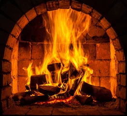 Papier peint photo autocollant rond Flamme A fire burns in a fireplace