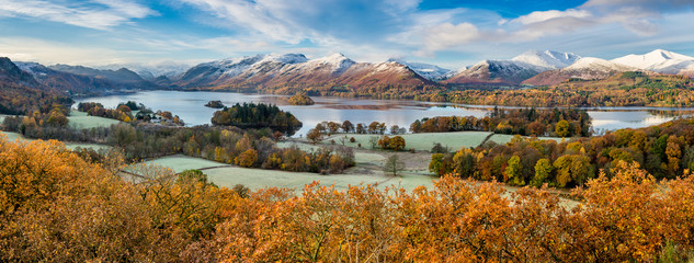 Beautiful view of Derwentwater in the English Lake District on a frosty Autumn morning with snow on the fells. - obrazy, fototapety, plakaty