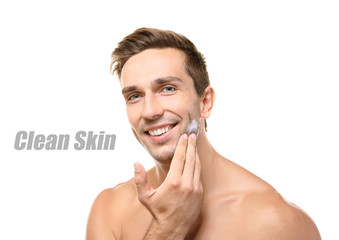 Skin care concept. Young man applying shaving foam, white background