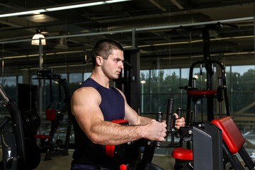 Fototapeta na wymiar Young handsome man training in gym