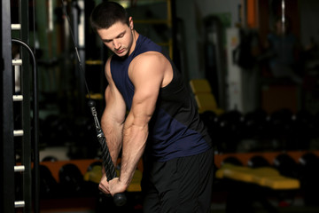 Fototapeta na wymiar Young handsome man training in gym