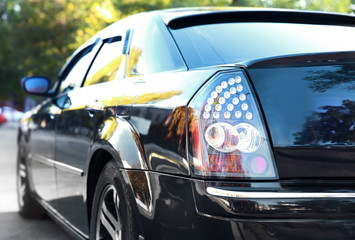 Fototapeta na wymiar Closeup of luxury black car, outdoors