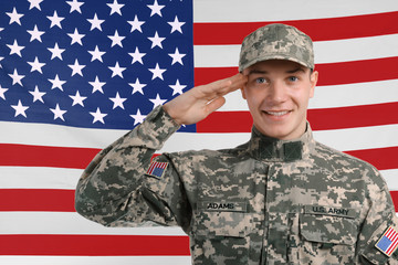 Saluting soldier with USA flag on background