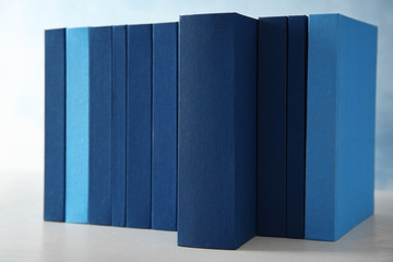 Set of books in row on blue background, closeup