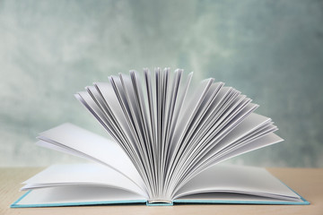 Open book on wooden table