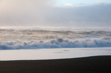 Fototapeta na wymiar crashing waves on black sand beach