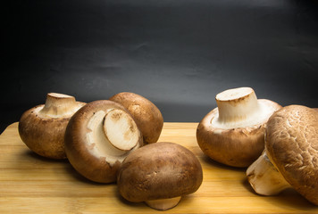 mushroom champignons on a wooden Board