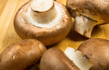 mushroom champignons on a wooden Board