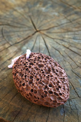 pumice stone with a cord on old wooden background