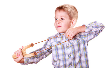 Young boy use sling shot shoot mandarine.