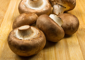 mushroom champignons on a wooden Board