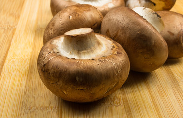 mushroom champignons on a wooden Board