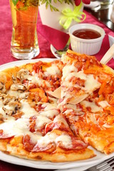 Pepperoni pizza with hot sauce and beer