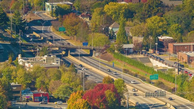 Vehicular Traffic Passing Downtown Asheville NC on I240 with Autumn Colored Trees on a Sunny Day during the Fall