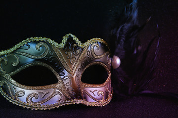 black venetian mask on glitter background