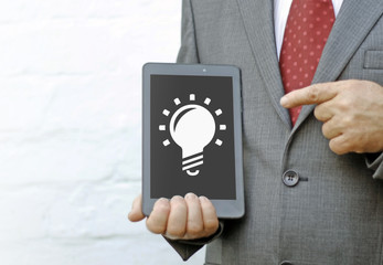 Bulb business industrial idea web tablet computer concept. Lightbulb gear icon brainstorm innovation inspiration technology