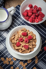 Tasty breakfast with milk and raspberries.