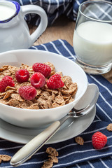 Tasty breakfast with milk and raspberries.