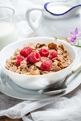 Tasty breakfast with milk and raspberries.
