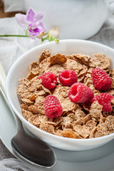 Tasty breakfast with milk and raspberries.