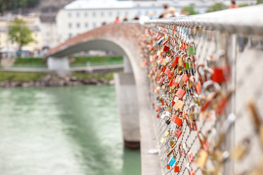The view to Makartsteg bridge over Salzach River, Austria's most modern pedestrian bridge in Salzburg, that attracts a lot of tourists and lovers that hand the padlocks.