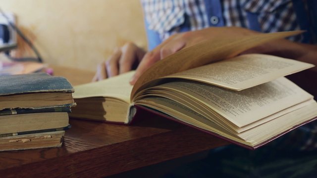 Man Reading An Old Education Book Close-up Turns The Page Video