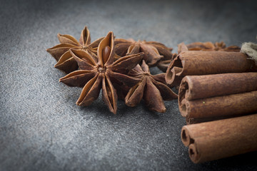 Star anise,cinnamon and licorice on grey background