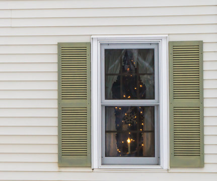   Window  With Shutters Curtains And  Winter Snowflake Decorations  Lit By  Holiday Candle 
