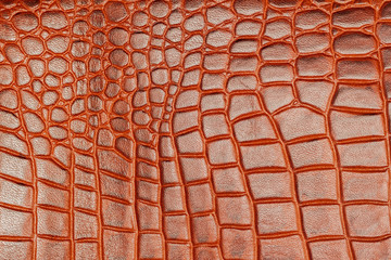 Brown scales macro background, embossed under the skin of a crocodile, cognac tones