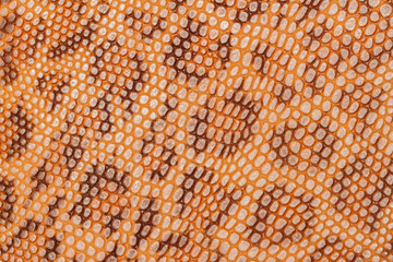 Spotted skin close up background, beautiful bright brown color leopard imitation