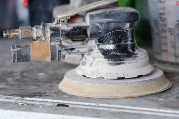 Close up grinder used in the body shops of the car repair stations