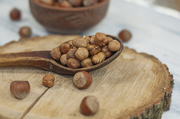 Shelled nuts, hazelnuts in a wooden spoon
