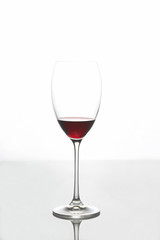 glass with red wine on a light background
