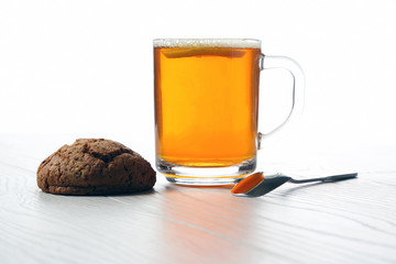 cup of tea with lemon and cookies on a wooden table