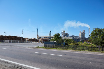 Wood factory with smoking chimneys