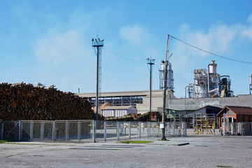 Fototapeta na wymiar Wood factory with smoking chimneys