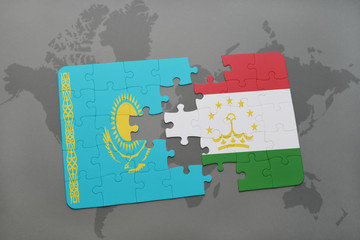 puzzle with the national flag of kazakhstan and tajikistan on a world map